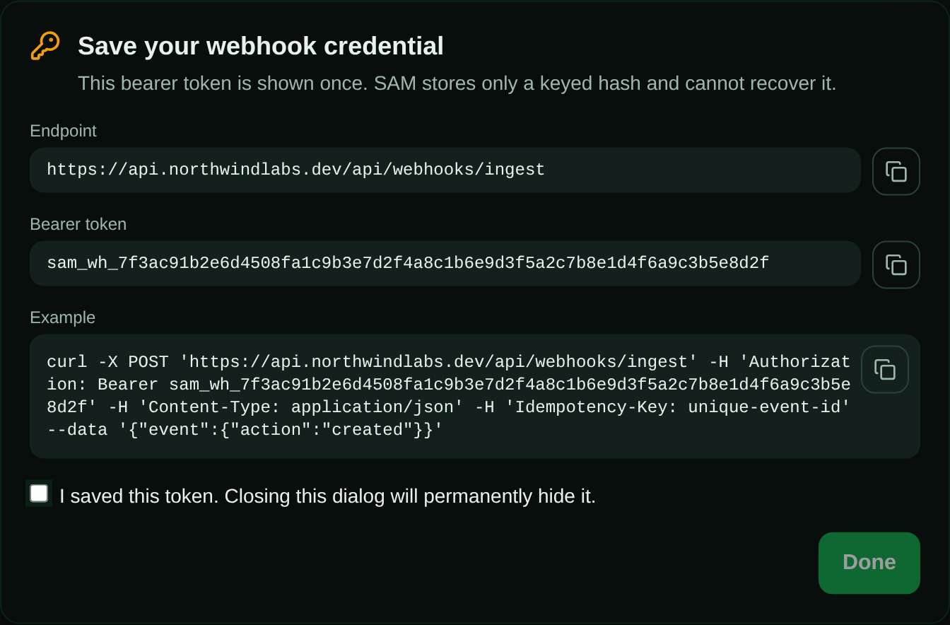 Save your webhook credential dialog showing the ingest endpoint URL, a one-time sam_wh_ bearer token, a curl example with an Idempotency-Key header, and an I saved this token checkbox